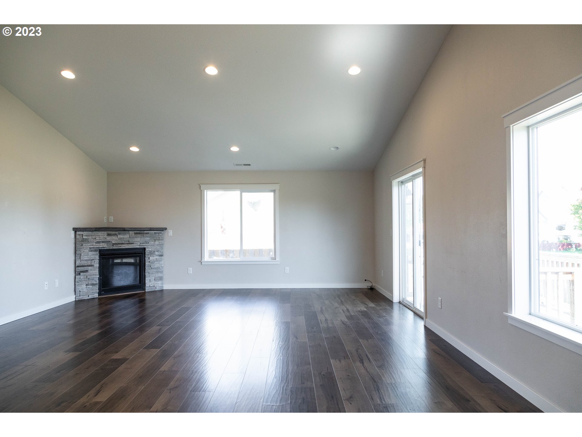 769 Southeast Meadows Loop Sheridan, OR 97378 - Photo 3 of 20 a view of an empty room with wooden floor and a window