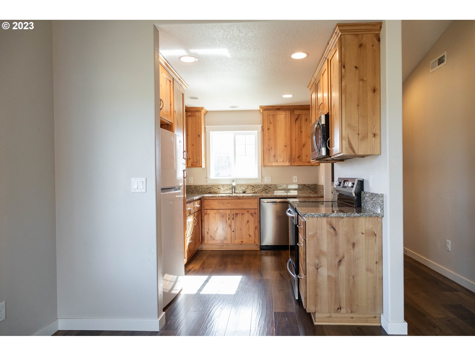 769 Southeast Meadows Loop Sheridan, OR 97378 - Photo 4 of 20 a kitchen with a refrigerator and a stove