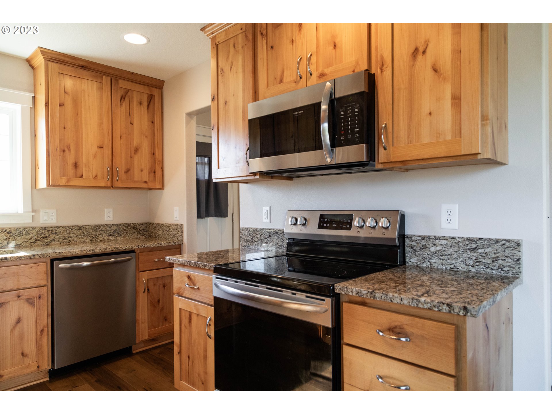 769 Southeast Meadows Loop Sheridan, OR 97378 - Photo 6 of 20 a kitchen with stainless steel appliances granite countertop a stove microwave and cabinets