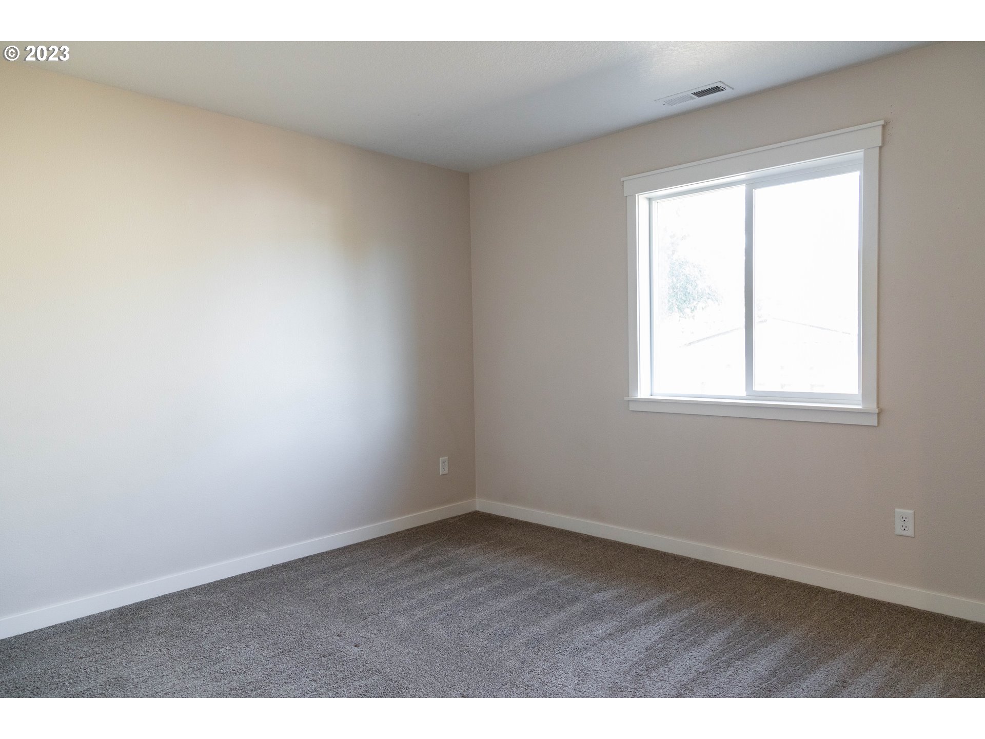769 Southeast Meadows Loop Sheridan, OR 97378 - Photo 9 of 20 an empty room with wooden floor and windows