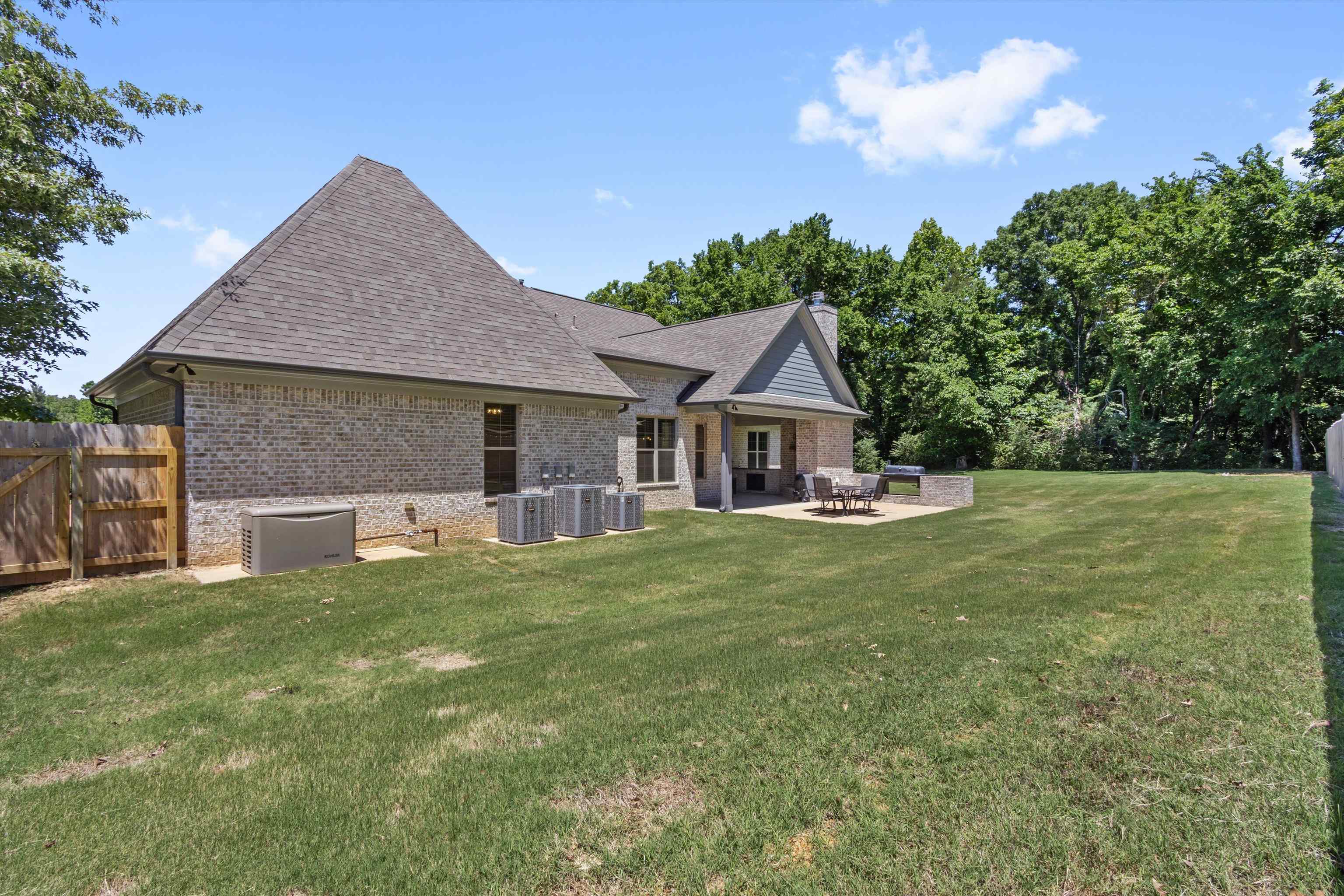 65 Watson Road Oakland, TN 38060 - Photo 36 of 40 a front view of a house with a garden