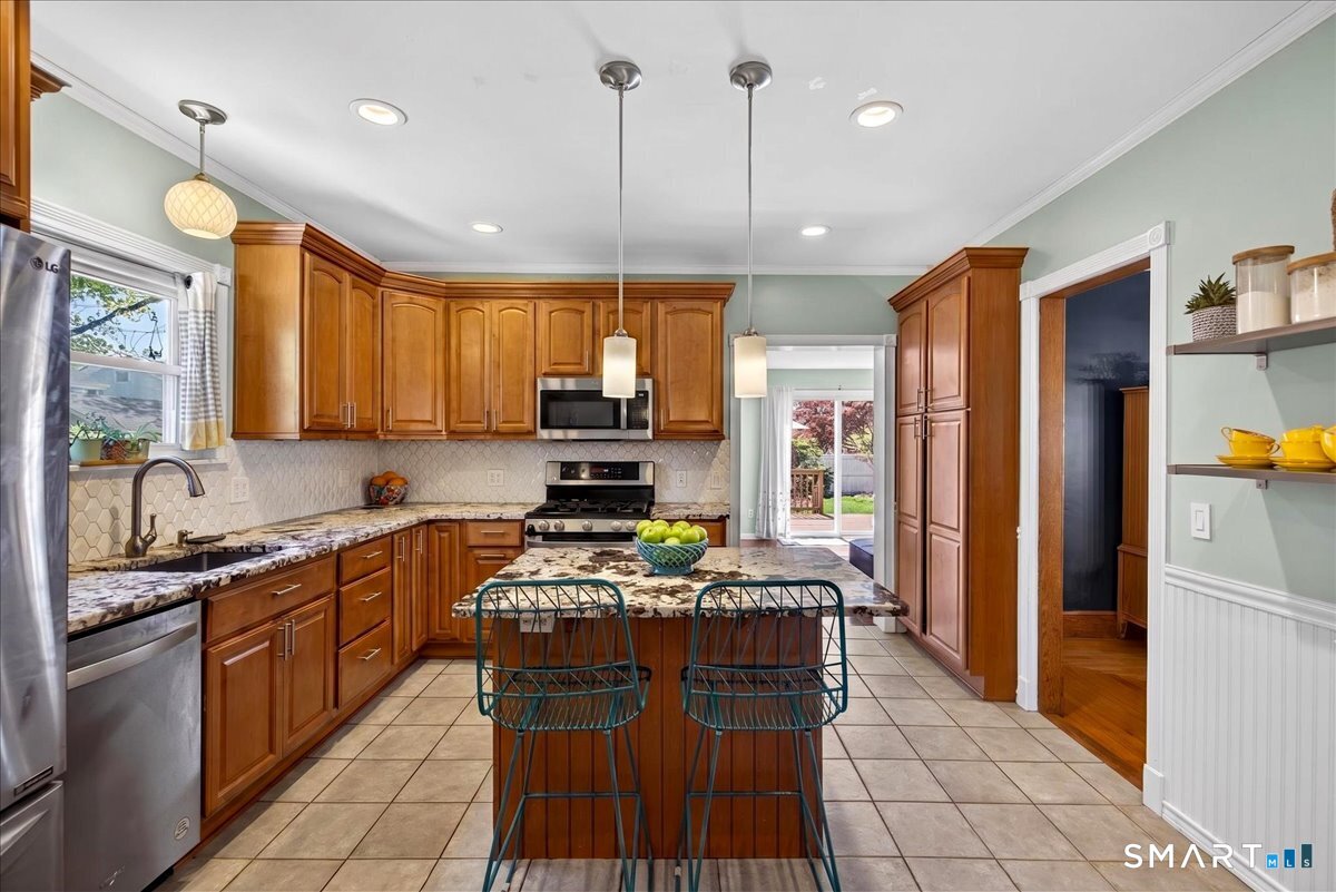 144 Mather Street Hamden, CT 06517 - Photo 11 of 40 a kitchen with stainless steel appliances granite countertop a stove top oven a refrigerator a sink and a microwave