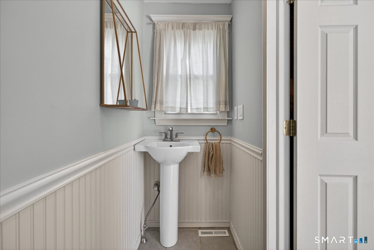 144 Mather Street Hamden, CT 06517 - Photo 15 of 40 a bathroom with a sink and mirror