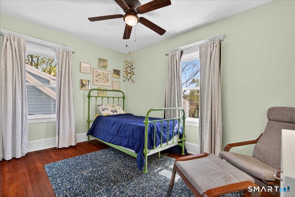 144 Mather Street Hamden, CT 06517 - Photo 16 of 40 a bedroom with a bed and wooden floor
