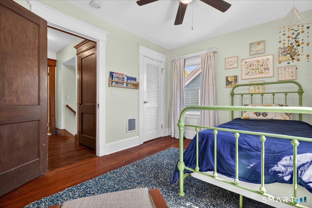 144 Mather Street Hamden, CT 06517 - Photo 17 of 40 a view of a bedroom with furniture and wooden floor