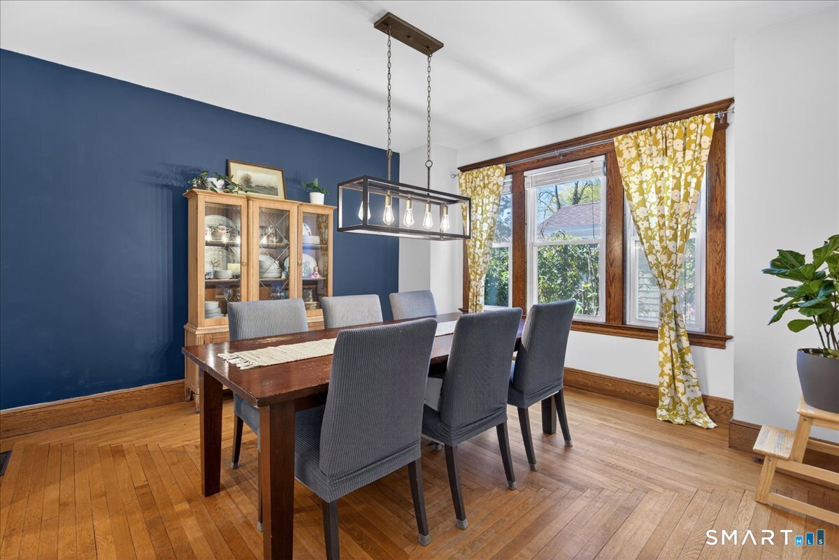 144 Mather Street Hamden, CT 06517 - Photo 7 of 40 a view of a dining room with furniture window and wooden floor