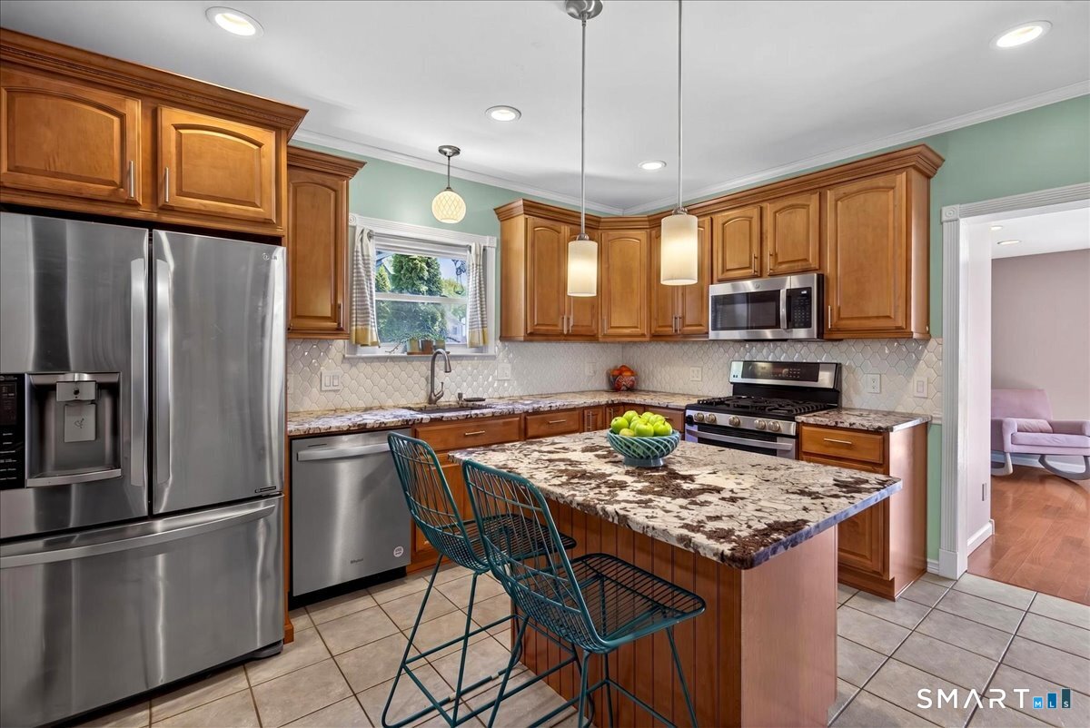 144 Mather Street Hamden, CT 06517 - Photo 10 of 40 a kitchen with stainless steel appliances granite countertop a stove refrigerator sink and microwave