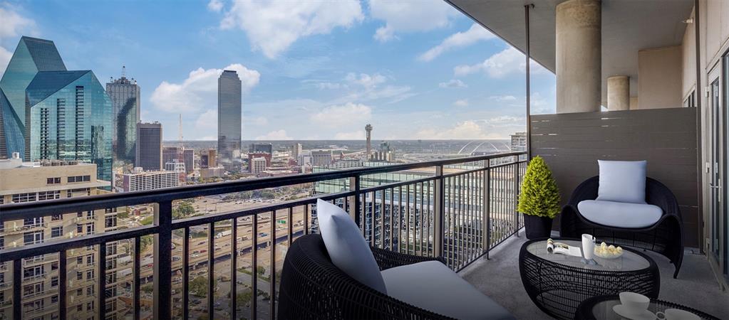 2323 North Akard Street, Unit 3102 Dallas, TX 75201 - Photo 1 of 1 a view of a balcony with chairs and a potted plant