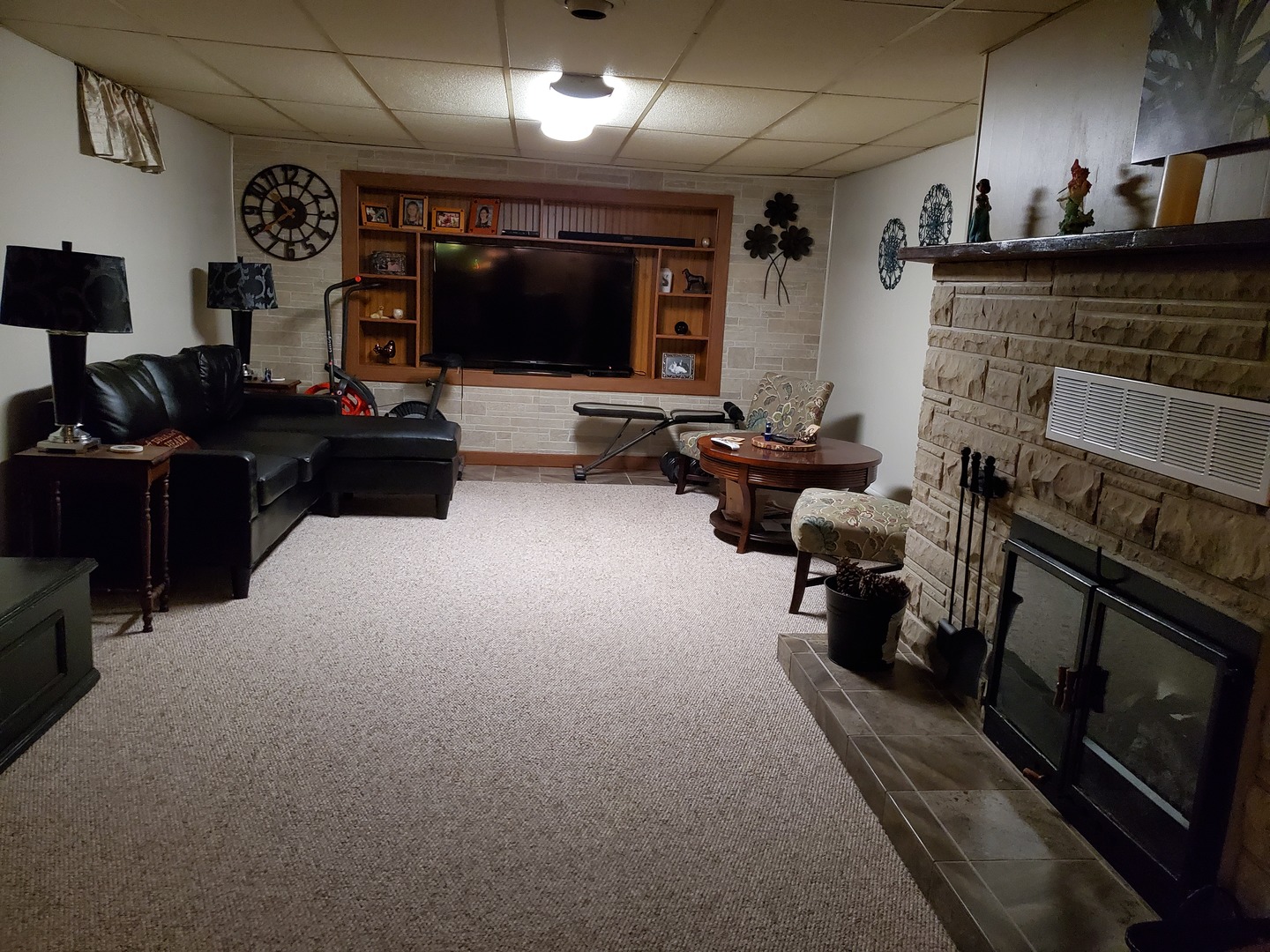 2502 Tower Road West Brooklyn, IL 61378 - Photo 13 of 26 a living room with furniture a flat screen tv and a fireplace