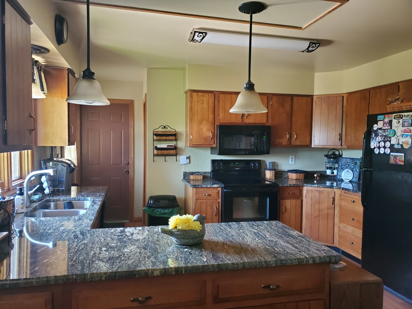2502 Tower Road West Brooklyn, IL 61378 - Photo 5 of 26 a kitchen with stainless steel appliances granite countertop a sink stove and refrigerator