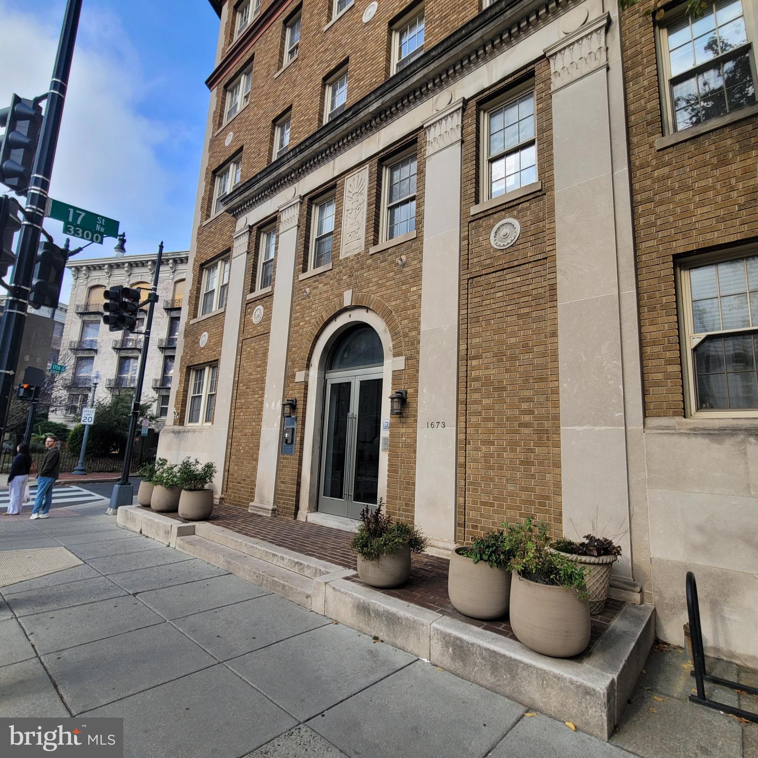 1673 Park Road Northwest, Unit 502 Washington, DC 20010 - Photo 22 of 23 front view of a brick house with potted plants