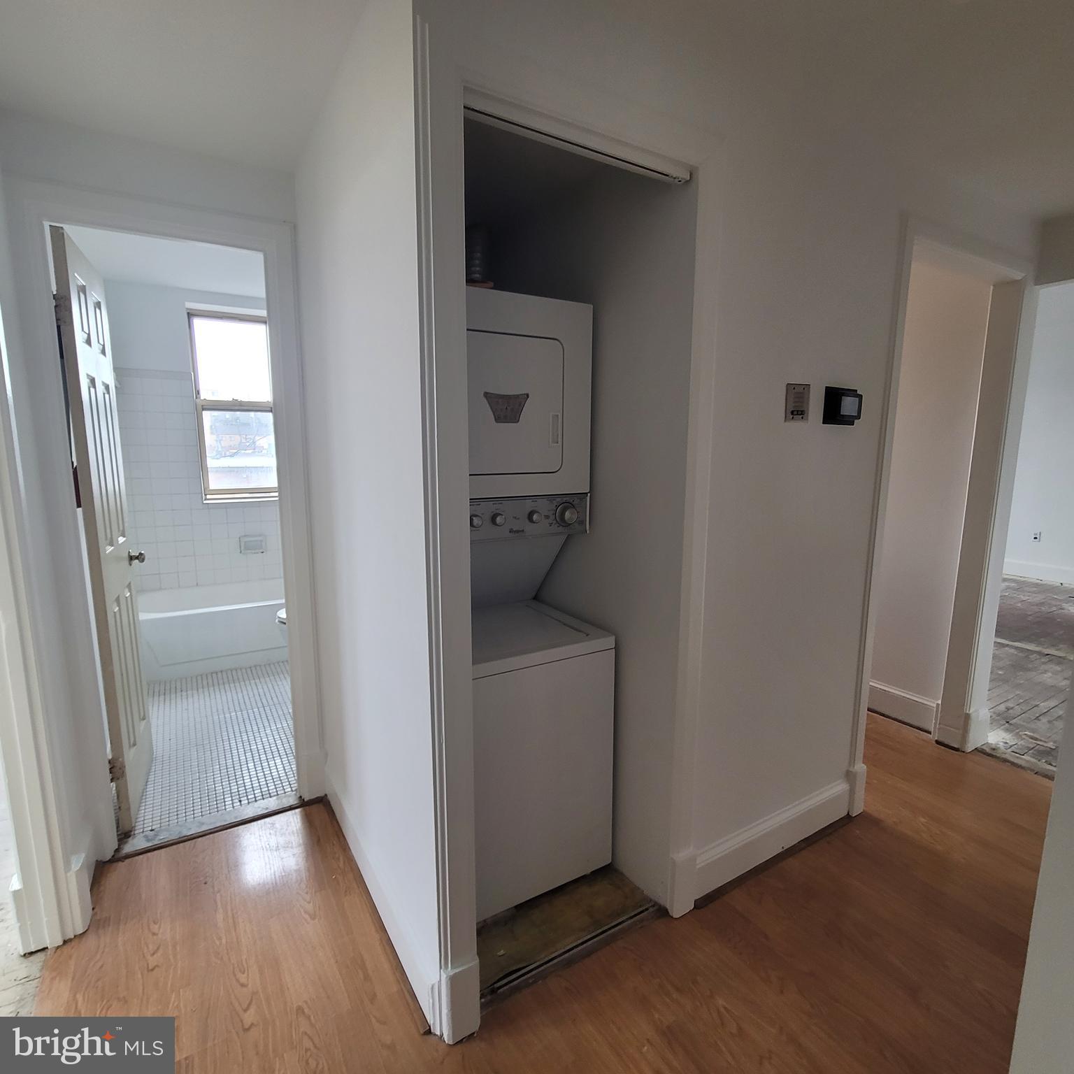 1673 Park Road Northwest, Unit 502 Washington, DC 20010 - Photo 8 of 23 a view of a hallway with wooden floor and a cabinet