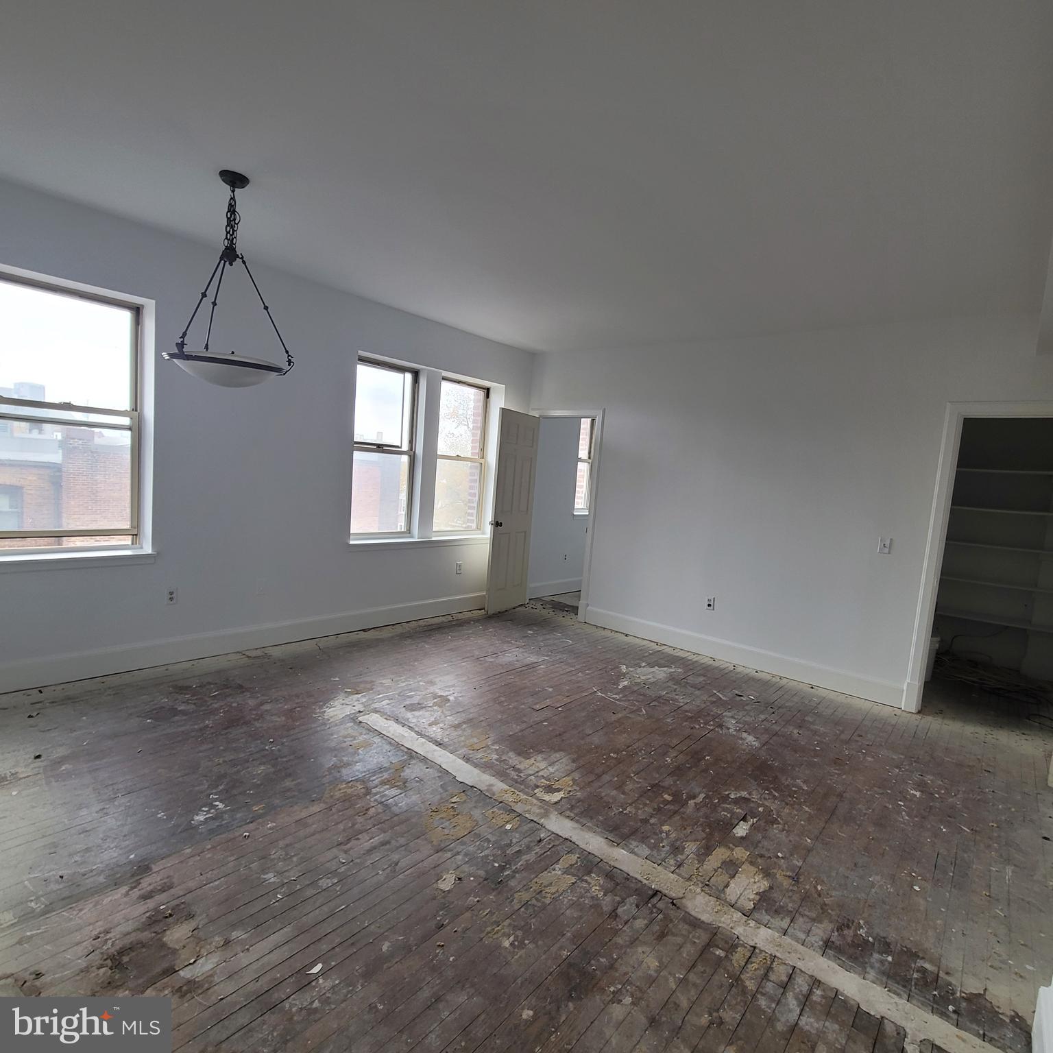 1673 Park Road Northwest, Unit 502 Washington, DC 20010 - Photo 10 of 23 an empty room with windows and ceiling fan