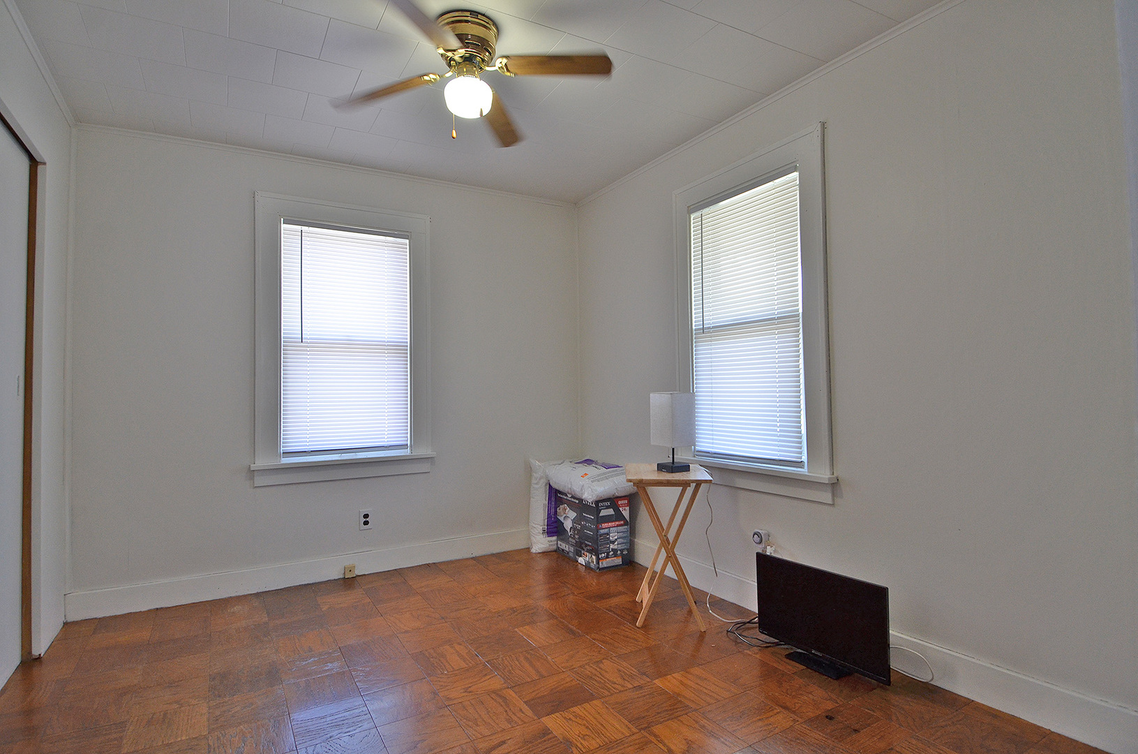 1617 Pine Street Ottawa, IL 61350 - Photo 5 of 13 an empty room with windows and fan
