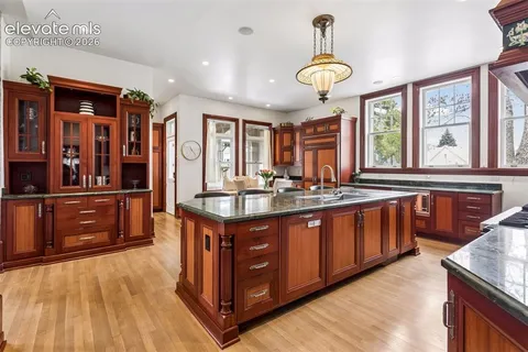 a kitchen with stainless steel appliances granite countertop a sink and a stove