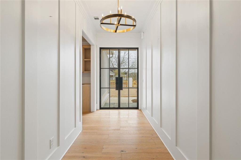 555 Lower Birmingham Road Canton, GA 30115 - Photo 21 of 104 a view of a hallway with wooden floor and a chandelier