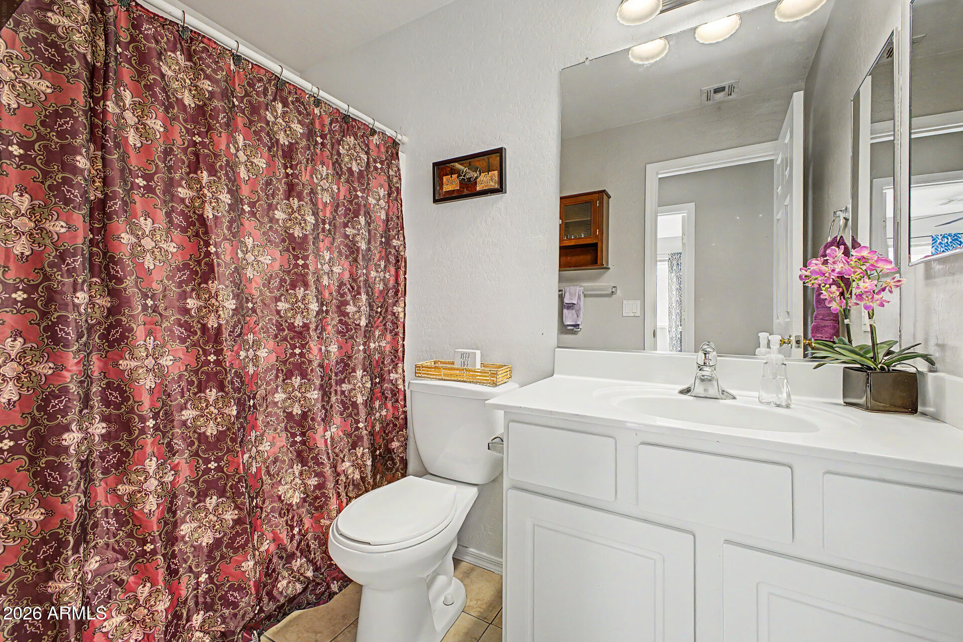 17236 West Durango Street Goodyear, AZ 85338 - Photo 11 of 14 a bathroom with a sink toilet and shower
