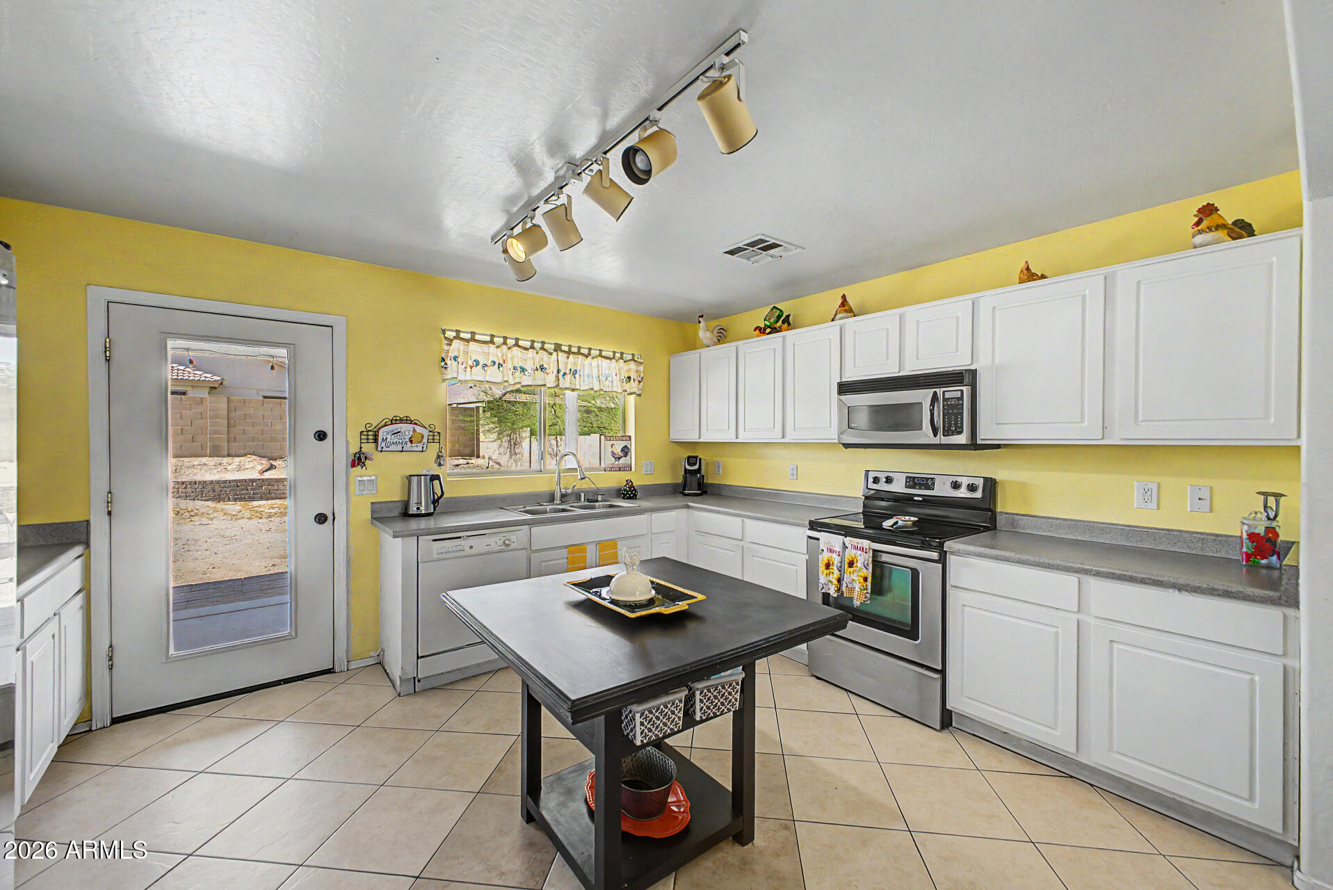 17236 West Durango Street Goodyear, AZ 85338 - Photo 6 of 14 a kitchen with stainless steel appliances a stove a sink dishwasher and cabinets with wooden floor