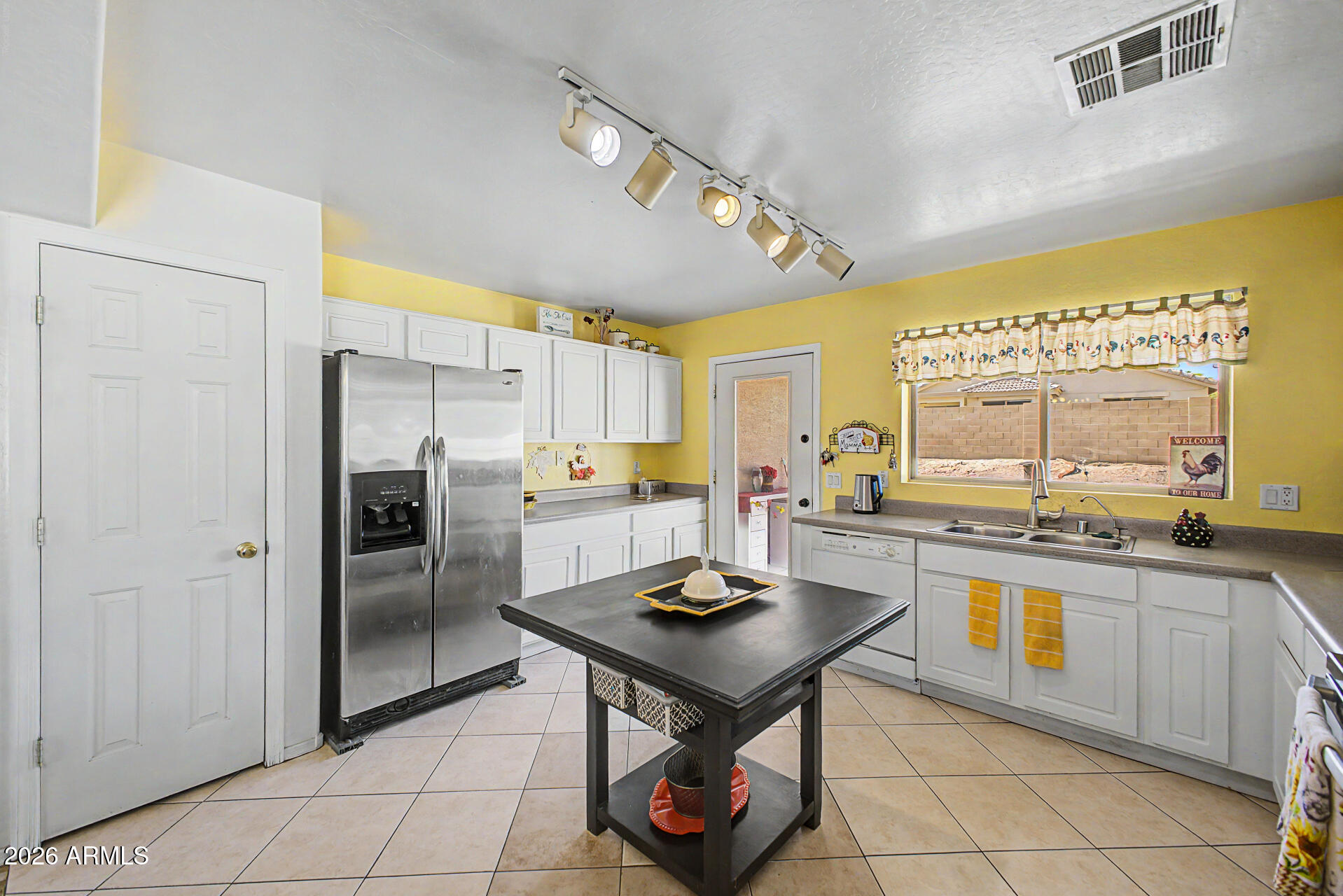 17236 West Durango Street Goodyear, AZ 85338 - Photo 7 of 14 a kitchen with stainless steel appliances granite countertop a sink a stove and refrigerator