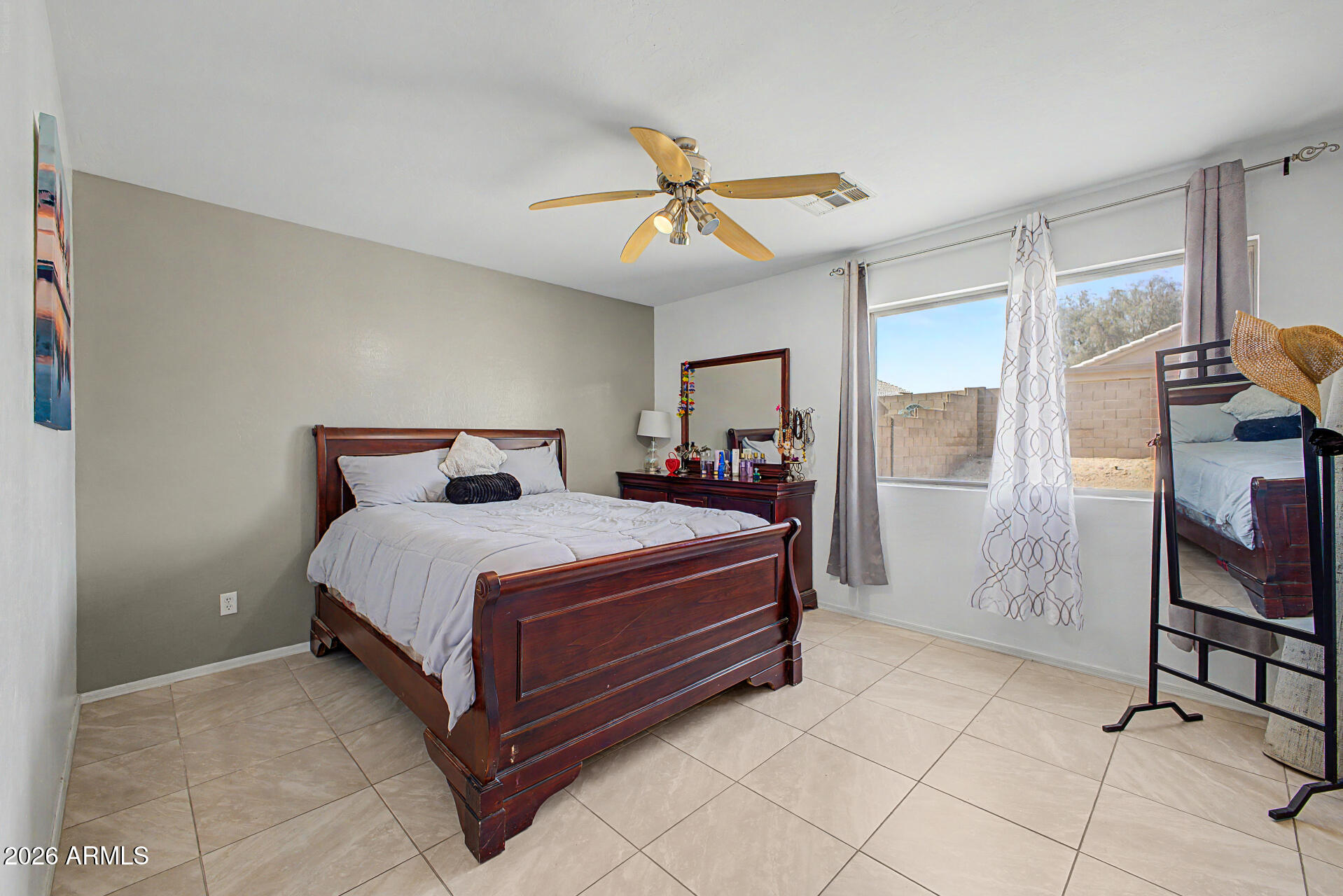 17236 West Durango Street Goodyear, AZ 85338 - Photo 8 of 14 a bedroom with a bed and window