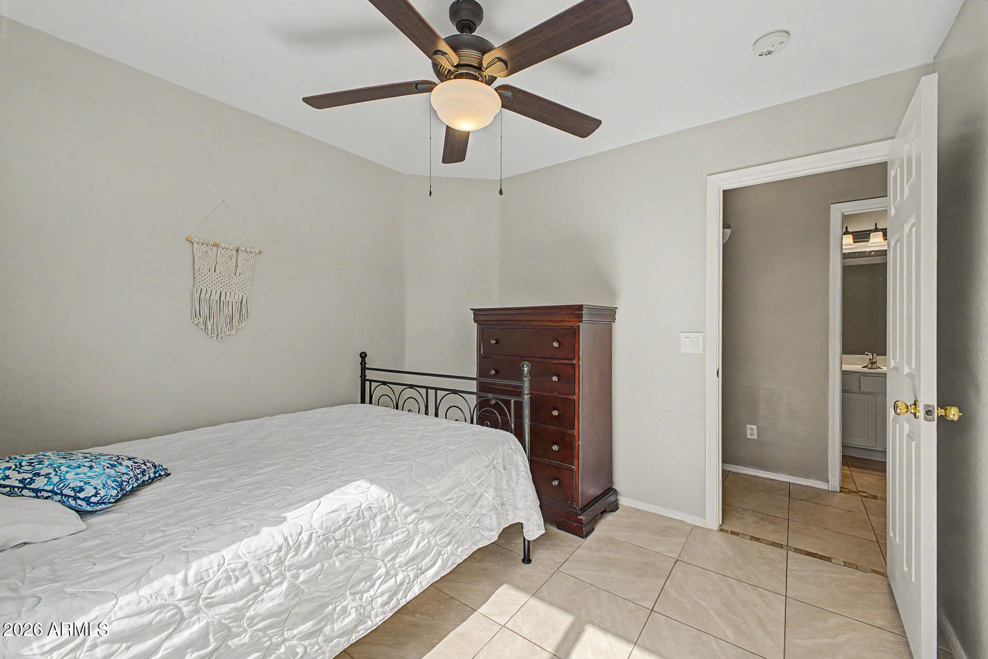 17236 West Durango Street Goodyear, AZ 85338 - Photo 10 of 14 a bedroom with a bed and a ceiling fan