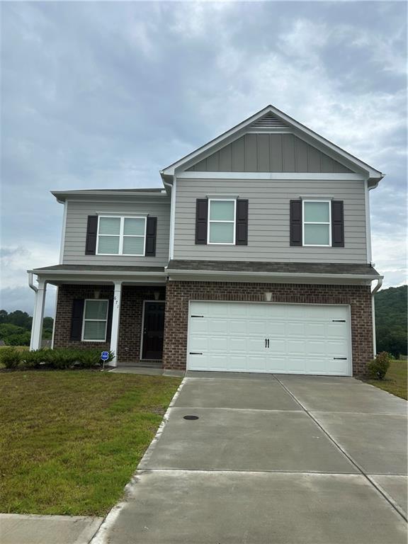 671 Mountaintop Road Cartersville, GA 30120 - Photo 2 of 14 a front view of a house with a garden