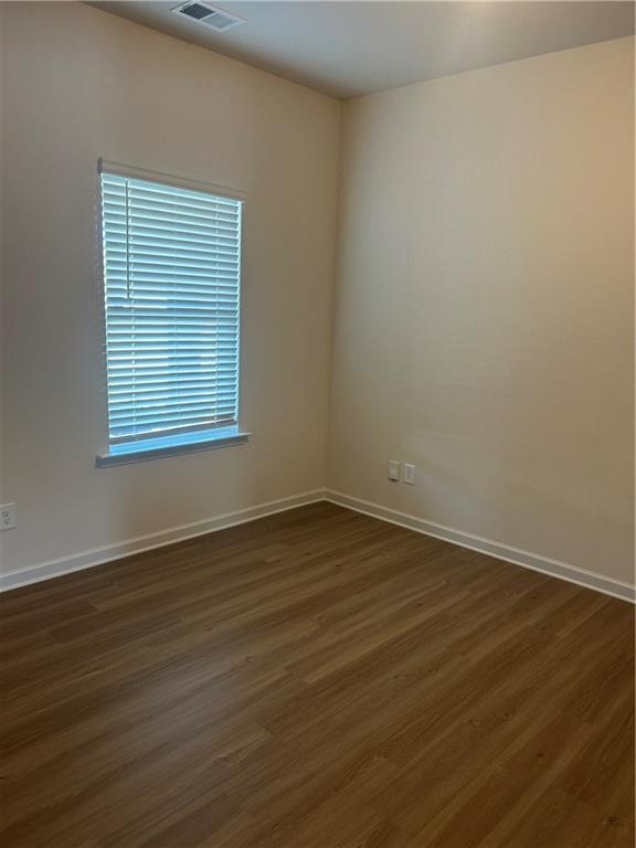 671 Mountaintop Road Cartersville, GA 30120 - Photo 5 of 14 a view of an empty room with wooden floor and a window