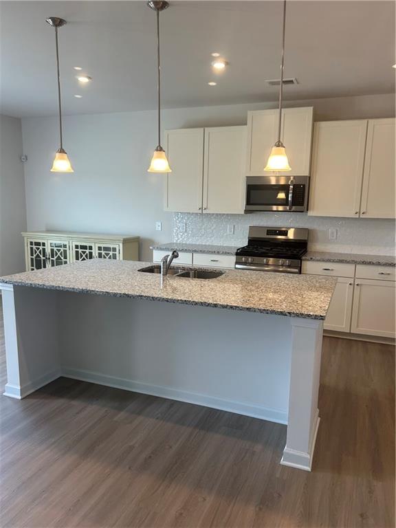 671 Mountaintop Road Cartersville, GA 30120 - Photo 7 of 14 a kitchen with kitchen island a counter space a sink and a stove