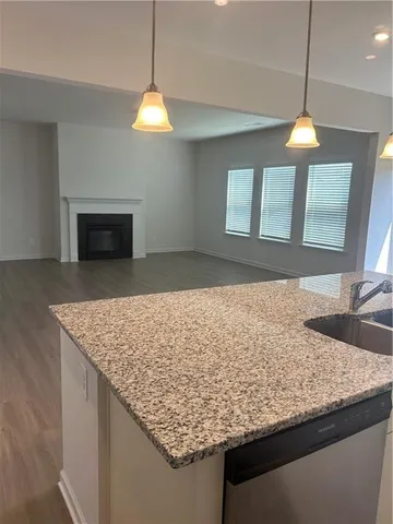 a kitchen with a sink chandelier and a fireplace