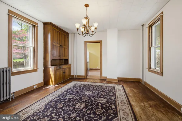 a kitchen with granite countertop a sink cabinets stainless steel appliances and a window