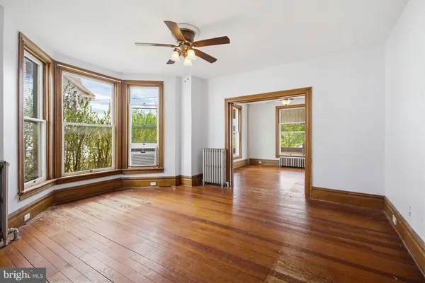 a view of hallway with wooden floor