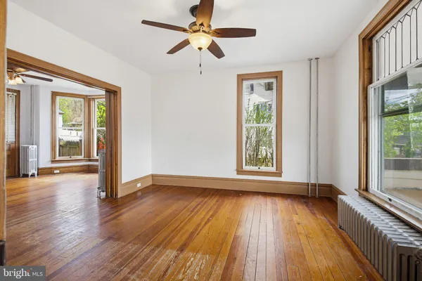 an empty room with windows and closet