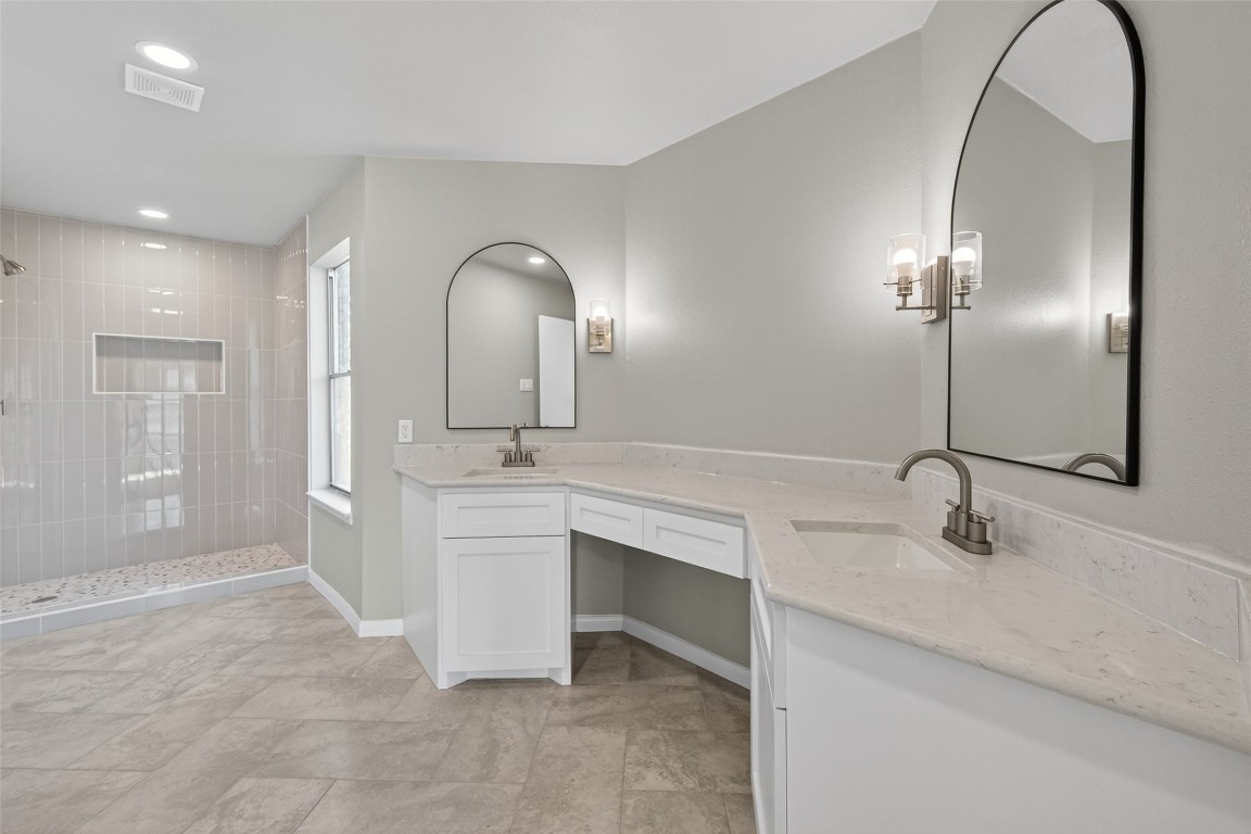 11406 Caesar Drive Houston, TX 77477 - Photo 12 of 32 a bathroom with a double vanity sink and a mirror