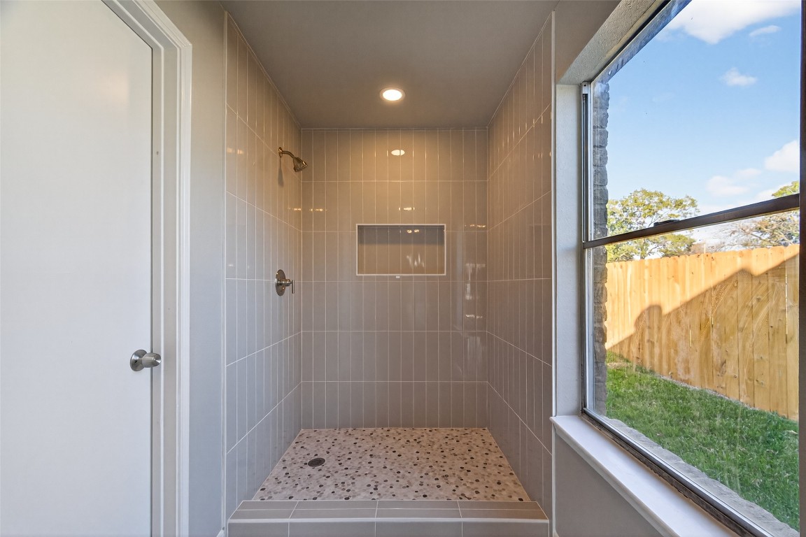 11406 Caesar Drive Houston, TX 77477 - Photo 22 of 32 a bathroom with a glass shower door