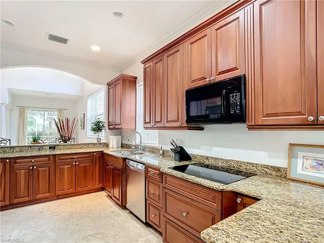 a kitchen with stainless steel appliances granite countertop wooden cabinets a sink and dishwasher