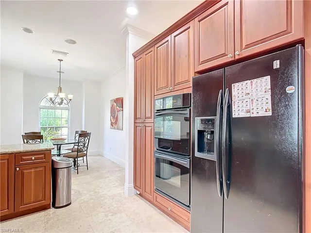 a view of kitchen with furniture and chandelier