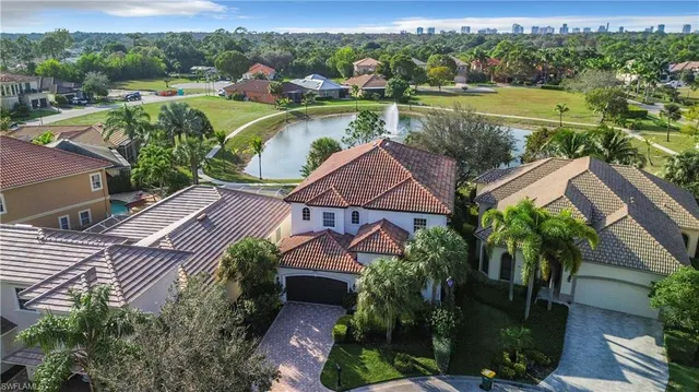 an aerial view of a house with garden space and a lake view