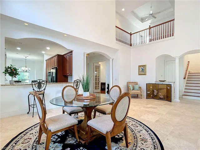 a dining room with furniture and a rug