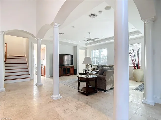a living room with furniture and a chandelier