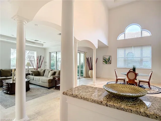 a dining room with furniture and a large window