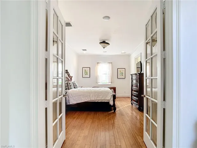 a bedroom with furniture and a wooden floor