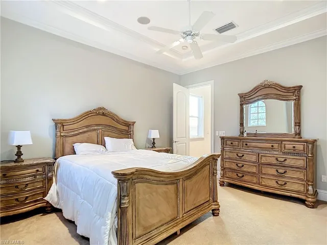a bedroom with a bed and a dresser in it