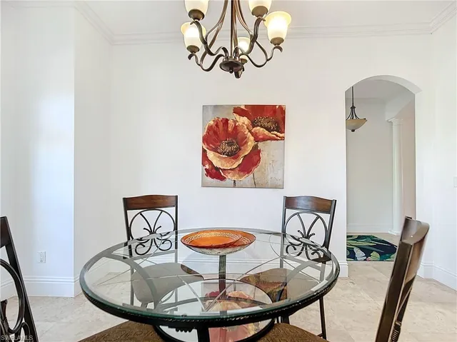 a view of a dining room with furniture and front door