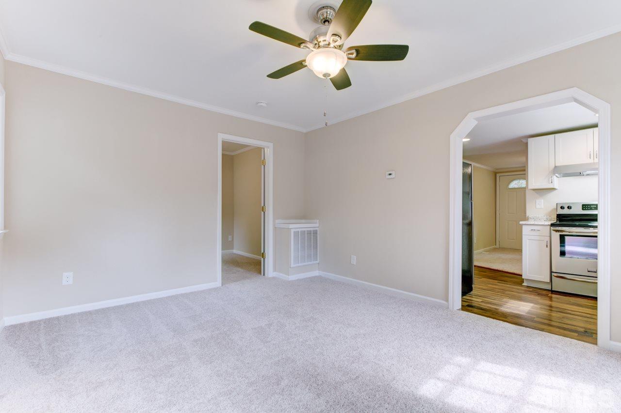 2308 Lilac Lane Raleigh, NC 27612 - Photo 17 of 25 wooden floor in an empty room with a ceiling fan