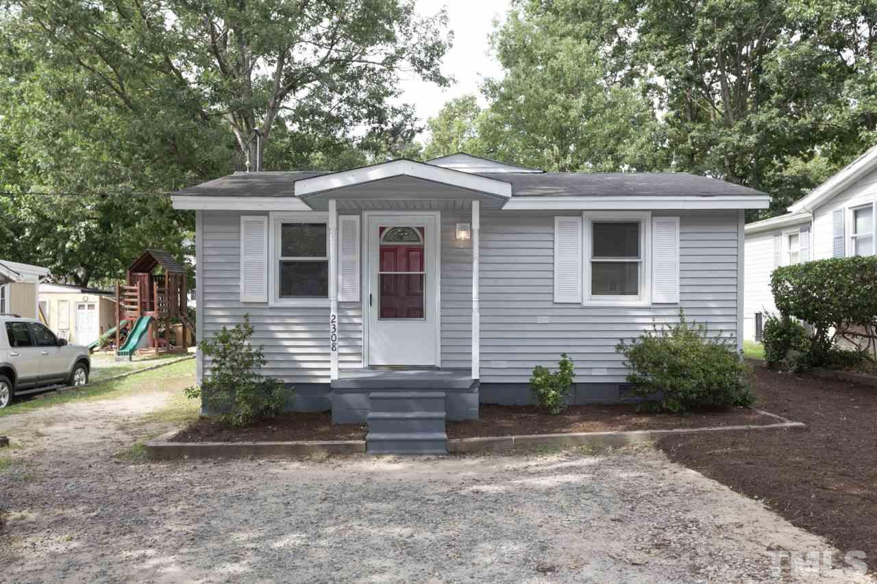 2308 Lilac Lane Raleigh, NC 27612 - Photo 3 of 25 a view of a house with a yard