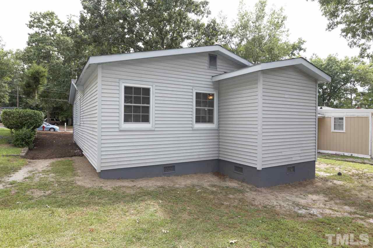 2308 Lilac Lane Raleigh, NC 27612 - Photo 25 of 25 a view of a small white house with a yard and garage