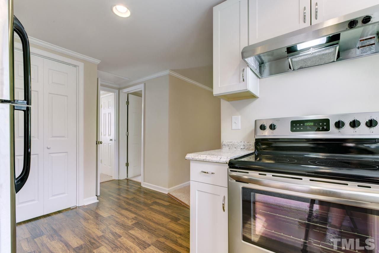 2308 Lilac Lane Raleigh, NC 27612 - Photo 9 of 25 a kitchen with stainless steel appliances granite countertop a stove and a refrigerator