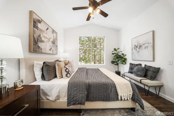 a spacious bedroom with a bed and a painting on the wall