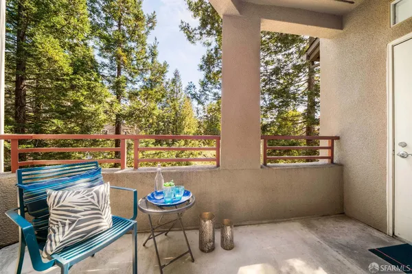 a porch with a bench and floor to ceiling window