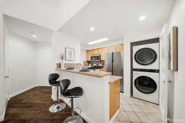 a kitchen with stainless steel appliances granite countertop a sink stove and cabinets